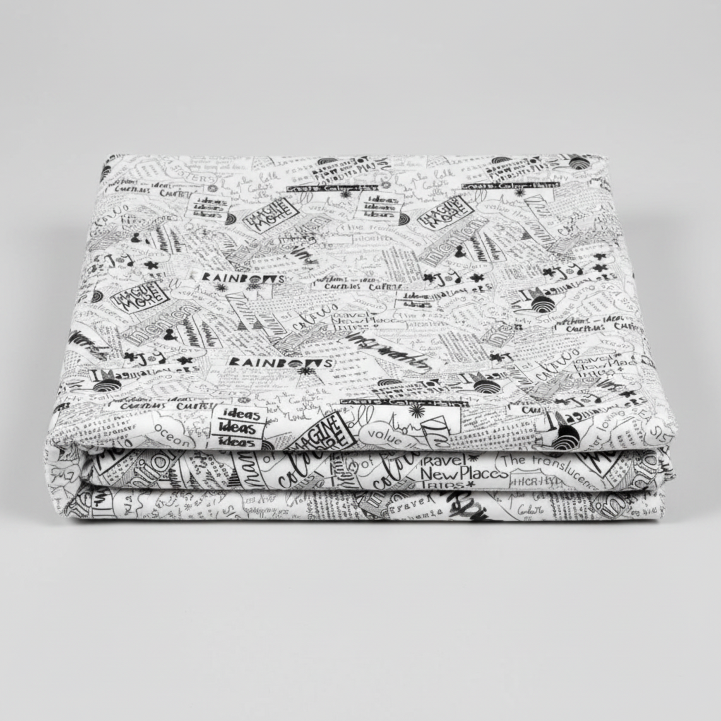 Writing on the Wall Word Collage White quilting cotton in soft fold stack — black and white word collage typography on white, FreeSpirit Fabrics